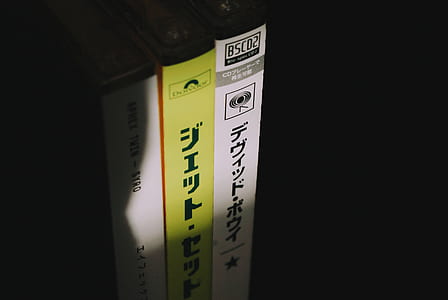 closeup photo of three disc cases thumbnail