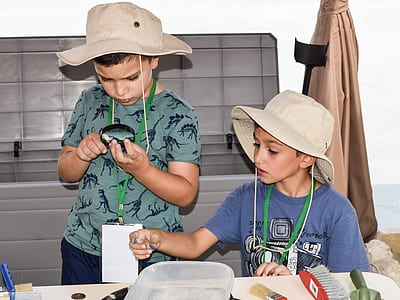 two kids handling bugs inside room thumbnail
