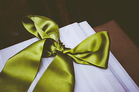 green satin ribbon on white surface thumbnail