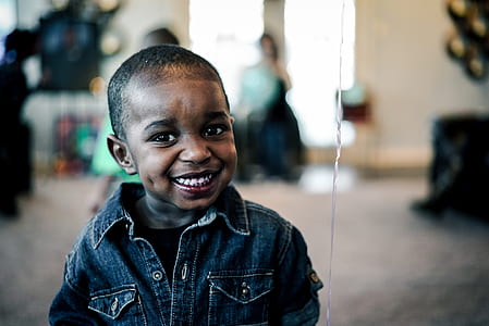 boy wearing denim top standing infront of mirror thumbnail