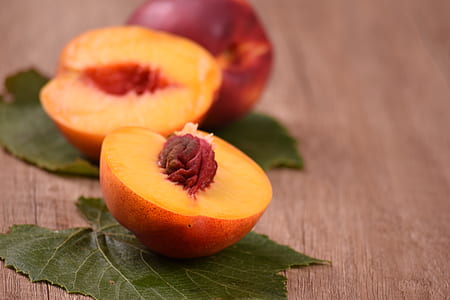 sliced peach on brown wooden surface thumbnail
