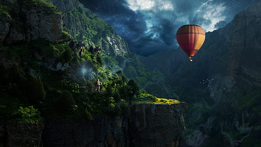 brown and red hot air balloon near mountain thumbnail