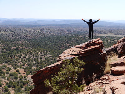person standing on orange boulder thumbnail