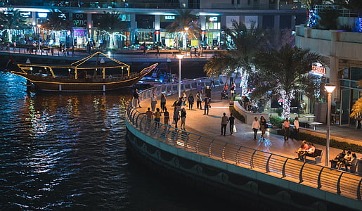 group of people standing on plaza near body of water thumbnail