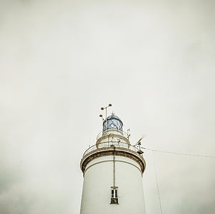 lighthouse under white sky thumbnail