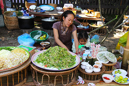 woman beside a girl near on plates thumbnail
