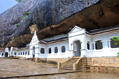 white concrete building under rock formation thumbnail