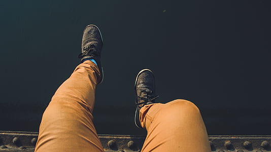 Person Wearing Brown Jeans With Pair of Black Sneakers thumbnail