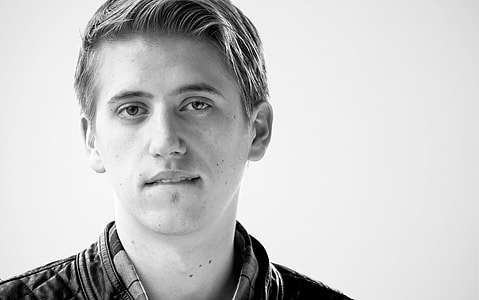 grayscale photo of person biting his lower lips thumbnail