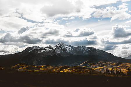 brown mountain under white clouds thumbnail