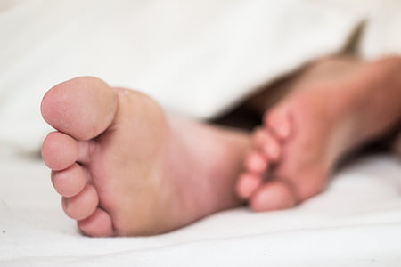 human feet on white textile thumbnail
