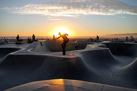 silhouette of man riding skateboard taken at sunset thumbnail