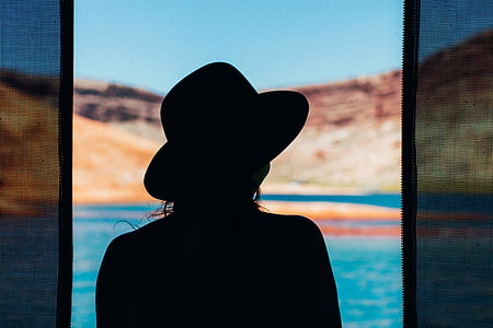 silhouette of woman facing to the body of water thumbnail