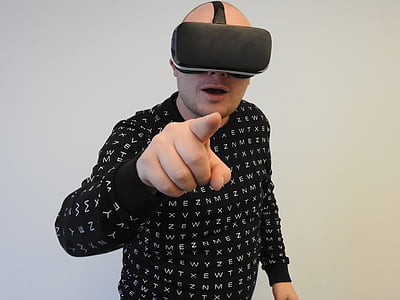 person wearing black crew-neck long-sleeved shirt using black virtual reality headset thumbnail
