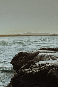 cliff surrounded by body of water thumbnail