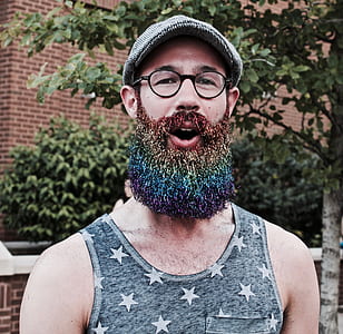 man opening his mouth while standing in front of green leaf tree during daytime thumbnail