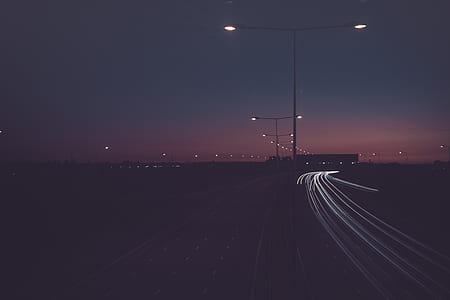 timelapse photo of city street under gray metal street post light during night time thumbnail