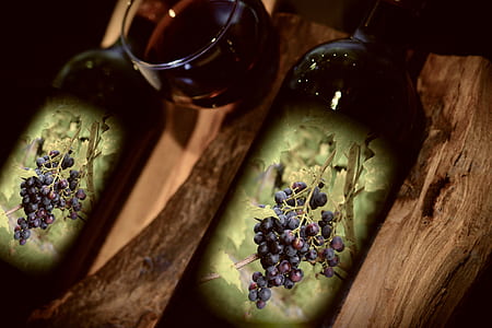 black and green bottle on brown wooden surface thumbnail