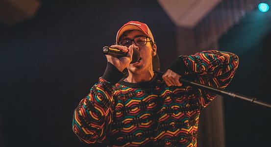 Man Holding Microphone in Shallow Photo thumbnail