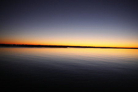 calm body of water at sunset thumbnail