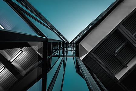 low-angle photograph of high-rise building under clear blue sky thumbnail