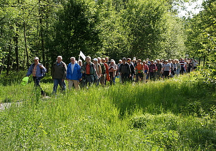 people walking beside of green grasses thumbnail