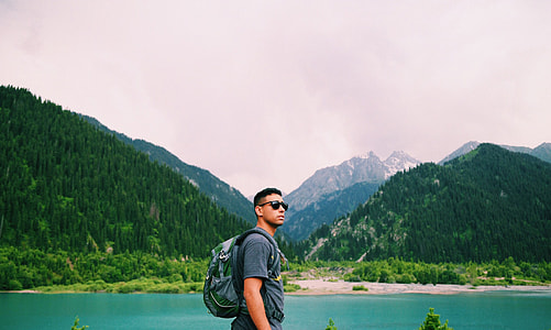 man carrying backpack thumbnail