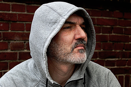 man in gray hoodie jacket looking in his left side thumbnail