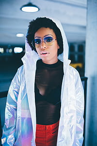 woman wearing white raincoat and aviator sunglasses thumbnail