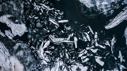 aerial and grayscale photography of ice on calm body of water thumbnail
