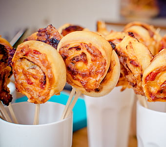 lollipop pastries in white ceramic mugs on table thumbnail