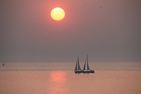 two white sailing boats under sunset thumbnail