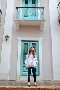 Woman Standing in Front of Teal Wooden Door thumbnail