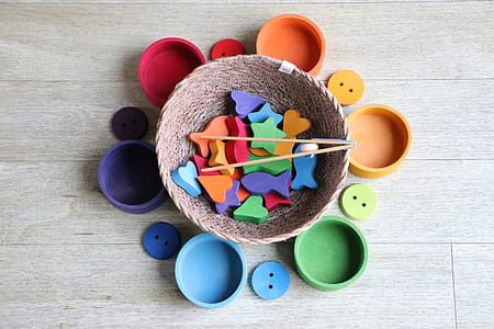 round brown wicker basket with multicolored shape toys thumbnail