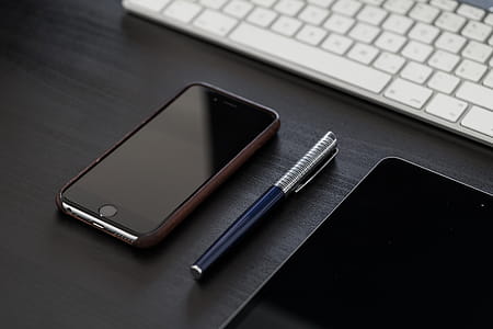 Black iPhone on Black Office Desk thumbnail