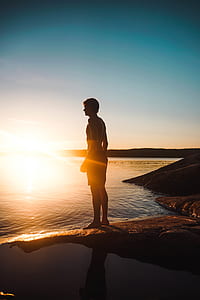 man standing beside shore thumbnail