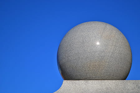 Gray Ball on Gray Surface With Blue Background thumbnail