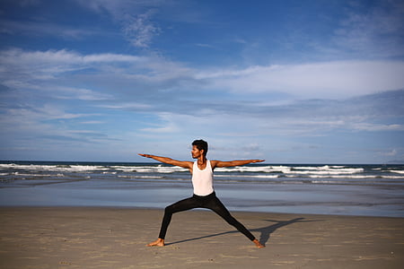 man wearing white tank top with black pants thumbnail