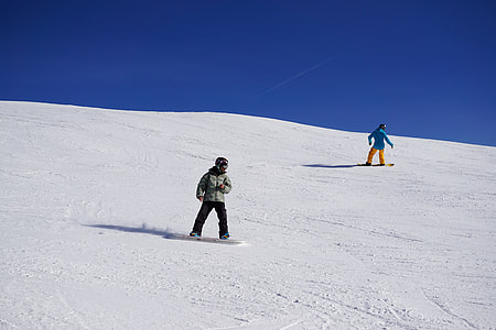 two child snowboarding on mountain thumbnail