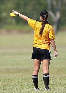 girl wearing soccer uniform holding yellow card thumbnail