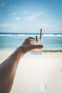 person holding liquor glass thumbnail