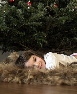 girl lying down on brown fur mat thumbnail