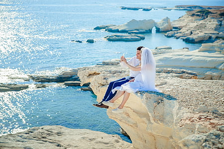 newlywed sitting on cliff thumbnail