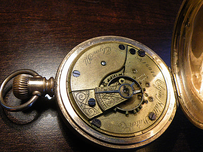 gold pocket watch on brown table thumbnail