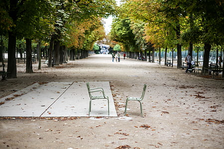 two gray chairs top of brown roadway thumbnail