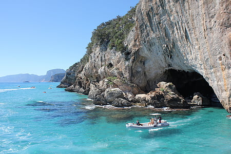 group of people riding white outboard boat on blue ocean water thumbnail
