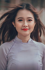 Woman Wearing White Long-sleeved Shirt Selective Focal Photo thumbnail