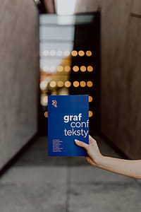 The woman is holding books in her hands thumbnail