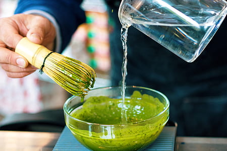 person pouring water into bowl thumbnail
