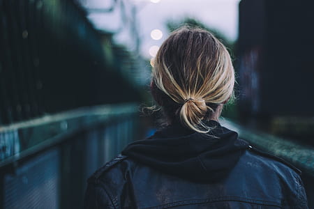 selective focus photography of woman's back wearing blue jacket thumbnail